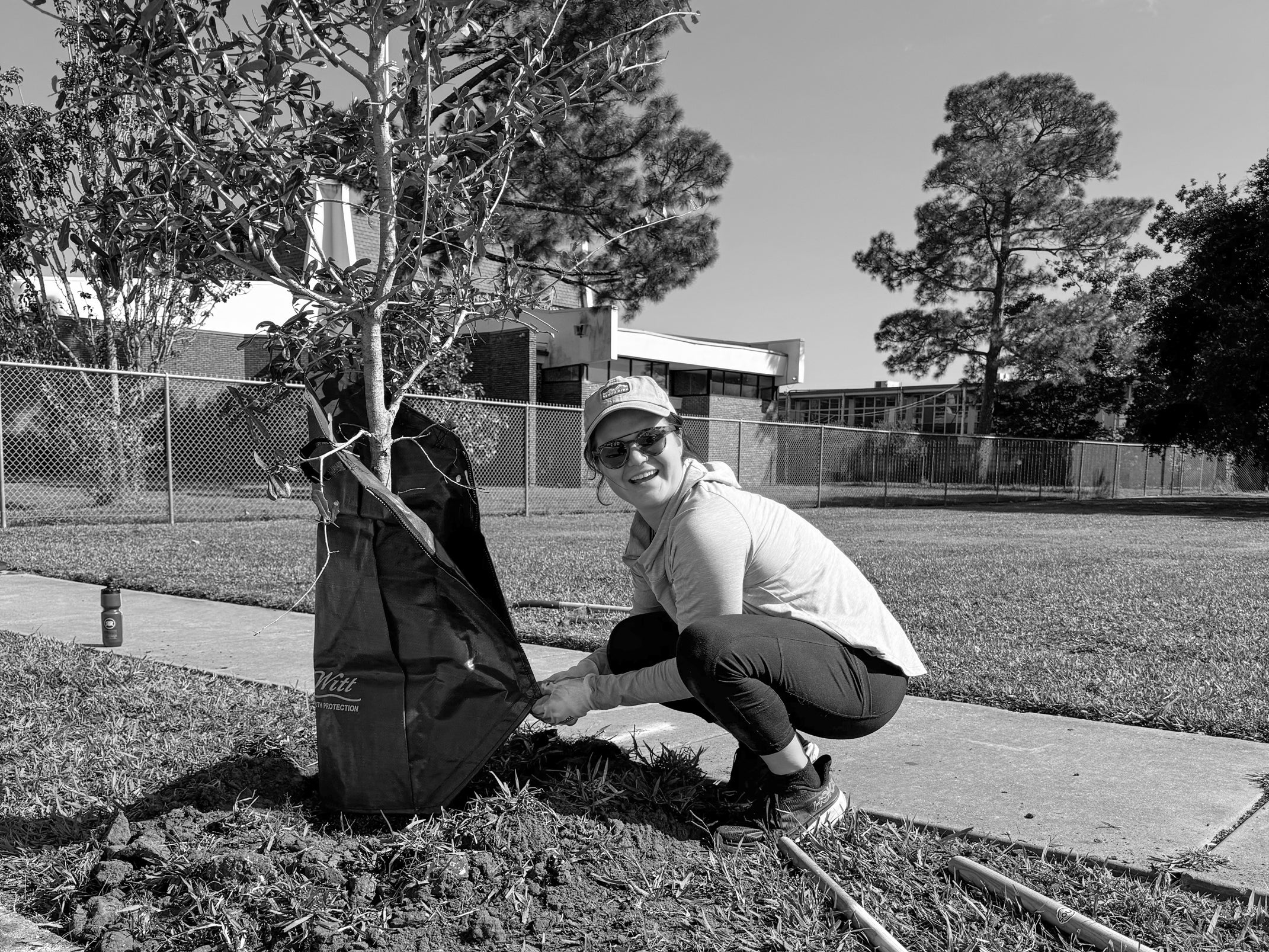 Catherine Flotte, Owner and Operator of Sprinkles Art Co, installs a water bag on a Live Oak Tree she just planted with Soul Nola in Gentilly Woods.
